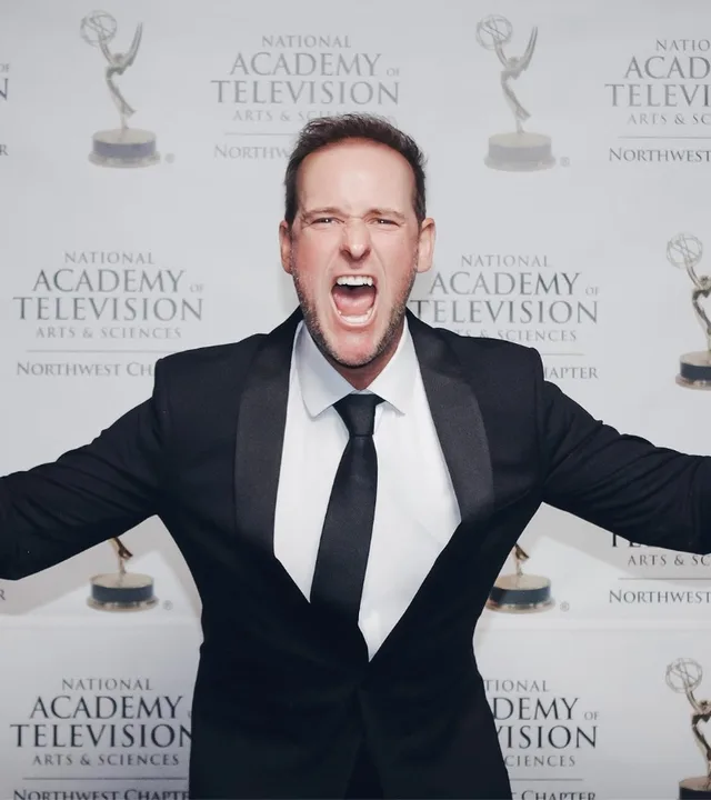 Director AJ Carter holding Emmy awards